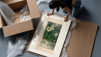 White hellebore flowers with sparrows framed print being unpacked from protective bubble wrap and a box