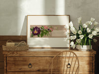 Purple pansy and pink blossom bouquet print in an oak frame on a farmhouse dresser beside white tulips