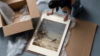 American robin perched on branch framed print being unpacked from protective bubble wrap and a box