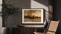 Winter landscape with ice skaters at dusk print in a wood frame above a fluted sideboard beside an olive tree