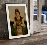 Young woman holding roses and book print in a black frame leaning beside a vintage door on parquet