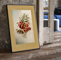 Autumn-tinted leaves branch print in a black frame leaning beside a vintage door on parquet