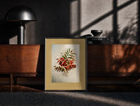 Black-framed Autumn-tinted leaves branch print on a moody console with designer coffee-table books
