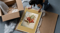 Autumn-tinted leaves branch framed print being unpacked from protective bubble wrap and a box
