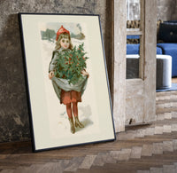 Girl carrying holly branches in apron print in a black frame leaning beside a vintage door on parquet