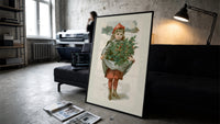 Girl carrying holly branches in apron print in a slim black frame leaning on a dark sofa in a concrete print studio
