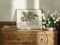 Holly sprig with red berries print in an oak frame on a farmhouse dresser beside white tulips