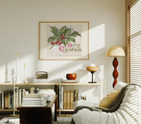 Holly sprig with red berries print in an oak frame above a mid-century book console with a vintage radio