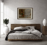 Two children with sled on ice print in a dark wood frame above a rattan bed on a plaster wall