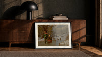 Two children with sled on ice print in a black frame leaning against a walnut console in lamplight