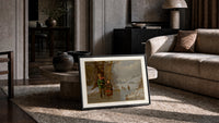 Two children with sled on ice print in a slim black frame leaning on a travertine coffee table