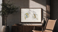 Two young girls holding flowers print in a wood frame above a fluted sideboard beside an olive tree