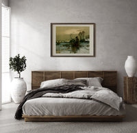 Winter landscape with bare trees print in a dark wood frame above a rattan bed on a plaster wall