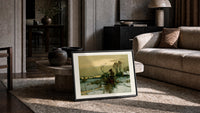 Winter landscape with bare trees print in a slim black frame leaning on a travertine coffee table