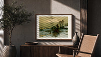 Winter landscape with bare trees print in a wood frame above a fluted sideboard beside an olive tree