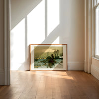 Winter landscape with bare trees print in an oak frame on a sunlit wood floor beneath tall window light