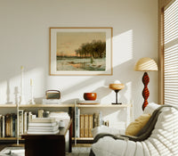 Winter landscape with frozen stream print in an oak frame above a mid-century book console with a vintage radio