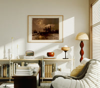 Moonlit winter church landscape print in an oak frame above a mid-century book console with a vintage radio