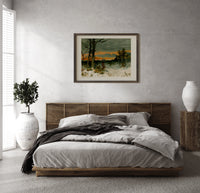 Woman walking through snowy winter landscape print in a dark wood frame above a rattan bed on a plaster wall