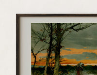 Close-up of the Woman walking through snowy winter landscape print's dark wood frame corner and archival matte paper