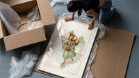 Victorian woman ice skating framed print being unpacked from protective bubble wrap and a box