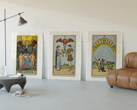 Three Rider-Waite tarot cards three-panel set displayed beside a brown leather sofa