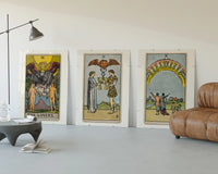 Three Rider-Waite tarot cards three-panel set displayed beside a brown leather sofa