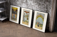 Three Rider-Waite tarot cards set of three black-framed prints leaning against a raw-plaster wall