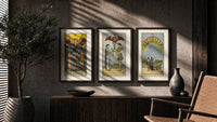 Three Rider-Waite tarot cards triptych in three walnut frames above a sideboard in a warm room