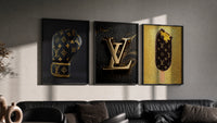 Louis Vuitton Pop Art Poster Set triptych in three black frames on a grey wall above a leather sofa