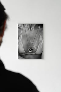 Chanel CC Necklace Black & White Fashion poster being unrolled on a concrete floor