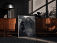 Black-framed Long-haired warrior with armor on cliff print on a moody console with designer coffee-table books