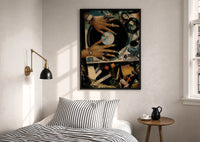 Manicured Hands on a Vinyl Record print in a black frame above a bed with striped linens