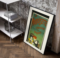 Two elegant women tasting liqueur poster in a black frame leaning beside a shelf in a raw-plaster loft