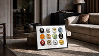 Martini and Disco Ball Circle Collage print in a black frame leaning on a rug beside a beige sofa