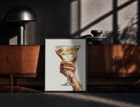 Black-framed Martini Glass print on the floor in front of a dark wooden console