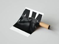Matte-black KAWS companion reclining with crossed arms on a clean white backdrop, shown rolled