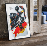 F1 driver celebrating beside race car print in a black frame leaning beside a vintage door on parquet