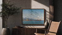 Coastal seascape with sailing boats print in a wood frame above a fluted sideboard beside an olive tree