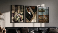 Mediterranean Escape Poster Set of 3 in black frames on a grey wall above a leather sofa