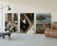 Mediterranean Escape Poster Set of 3 displayed beside a brown leather sofa