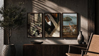 Mediterranean Escape Poster Set of 3 in walnut frames above a sideboard in a warm room