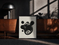 Black-framed Melting 8 Ball print on the floor in front of a dark wooden console