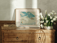 Vintage biplane flying in snow print in an oak frame on a farmhouse dresser beside white tulips