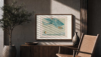 Vintage biplane flying in snow print in a wood frame above a fluted sideboard beside an olive tree