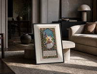 Snow-covered cottage in winter print in a black frame leaning on a travertine table in a sunlit lounge