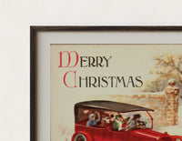 Close-up of the Vintage red touring car in snow print's dark wood frame corner and archival matte paper