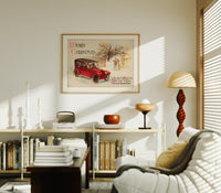 Vintage red touring car in snow print in an oak frame above a mid-century book console with a vintage radio