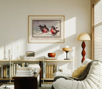 Two red robins on branch print in an oak frame above a mid-century book console with a vintage radio