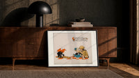 Soldier reading French book with child print in a black frame leaning against a walnut console in lamplight